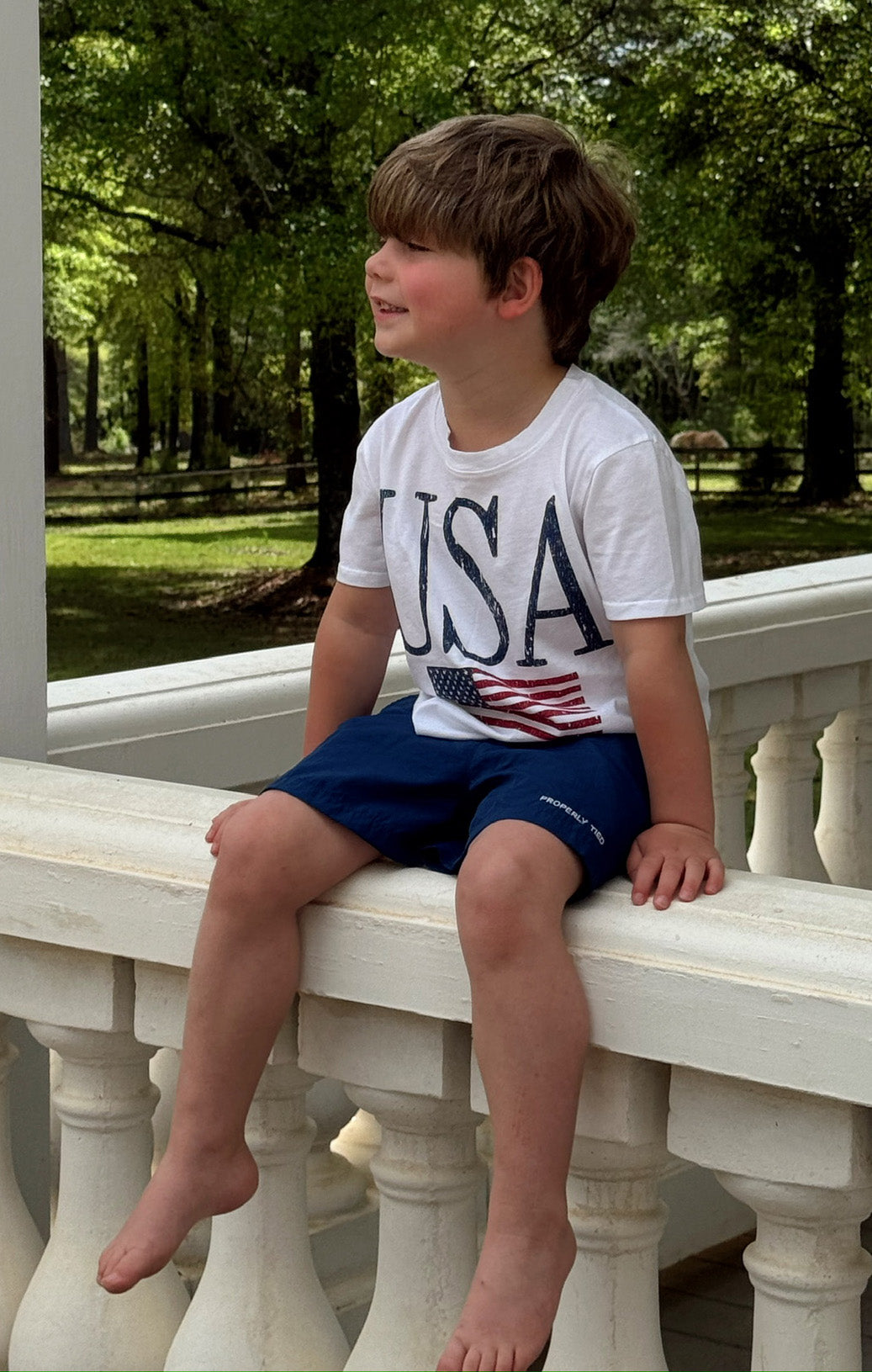 USA Flag Graphic Baby Tee | Little Travis Tee